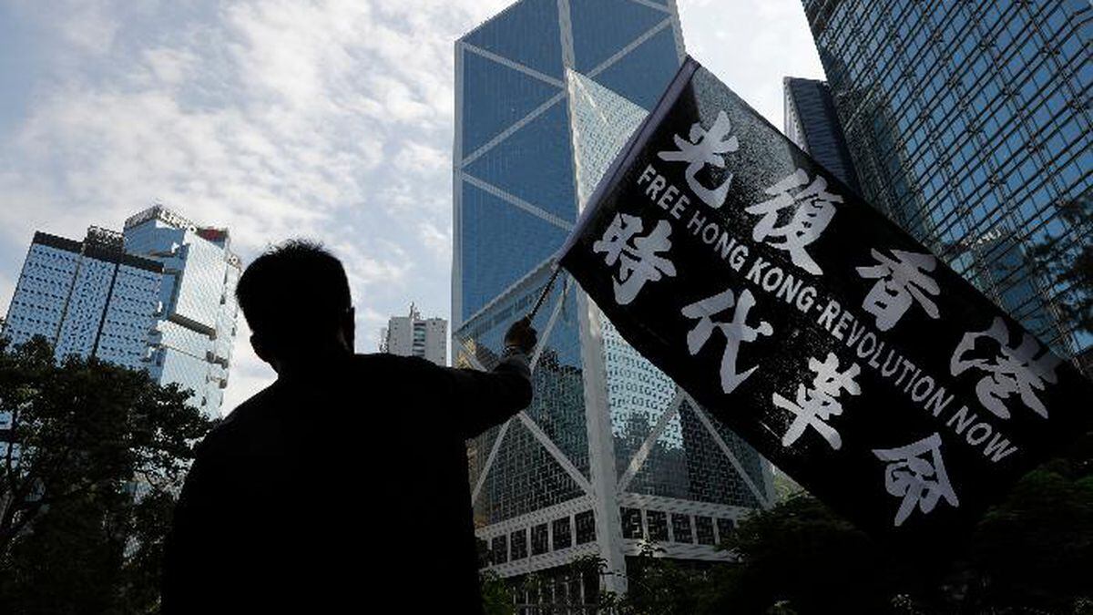 A pro-democracy supporter waves a flag during a rally by the advertising industry in Hong Kong on Monday, Dec. 2, 2019. Thousands of people took to Hong Kong's streets Sunday in a new wave of pro-democracy protests, but police fired tear gas after some demonstrators hurled bricks and smoke bombs, breaking a rare pause in violence that has persisted during the six-month-long movement. (AP Photo/Vincent Thian) (Source: Vincent Thian)