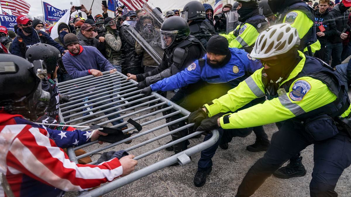 FILE - In this file photo from Wednesday Jan. 6, 2021, Trump supporters beset a police barrier...