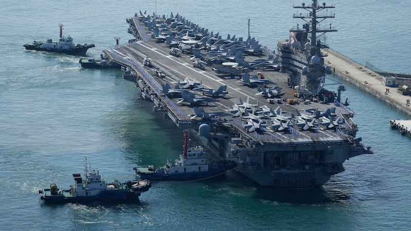The U.S. carrier USS Ronald Reagan is escorted as it arrives in Busan, South Korea, Friday,...