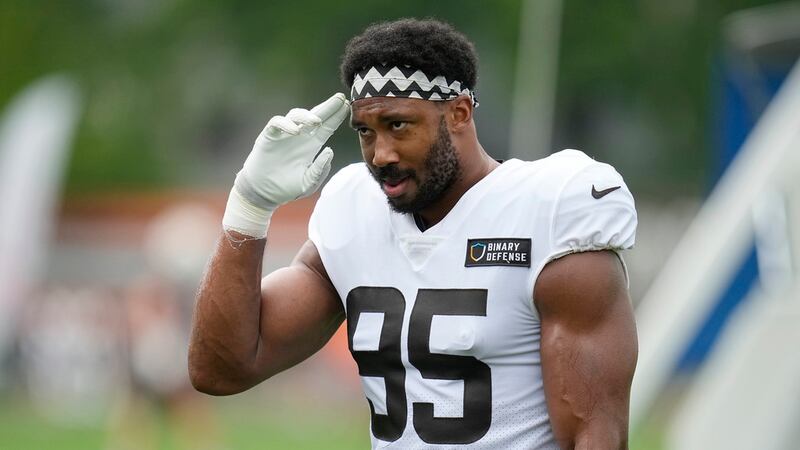 Cleveland Browns' Myles Garrett gestures to fans during an NFL football camp, Monday, Aug. 7,...
