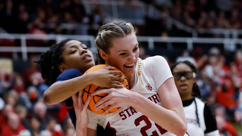 Mississippi guard Angel Baker, left, and Stanford forward Cameron Brink, right, vie for the...